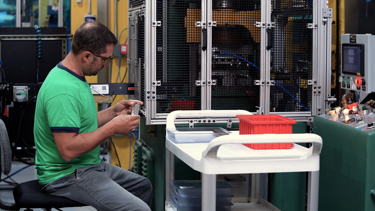 US Digital machine operator manually inspecting lead frames