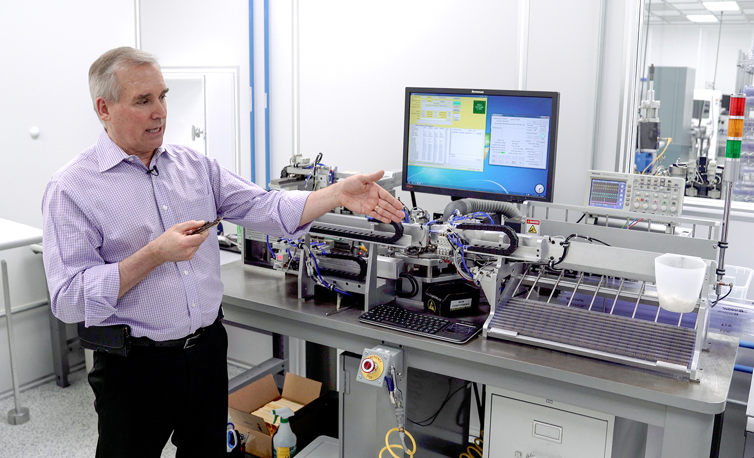 US Digital founder and CEO David Madore in front of automated machine